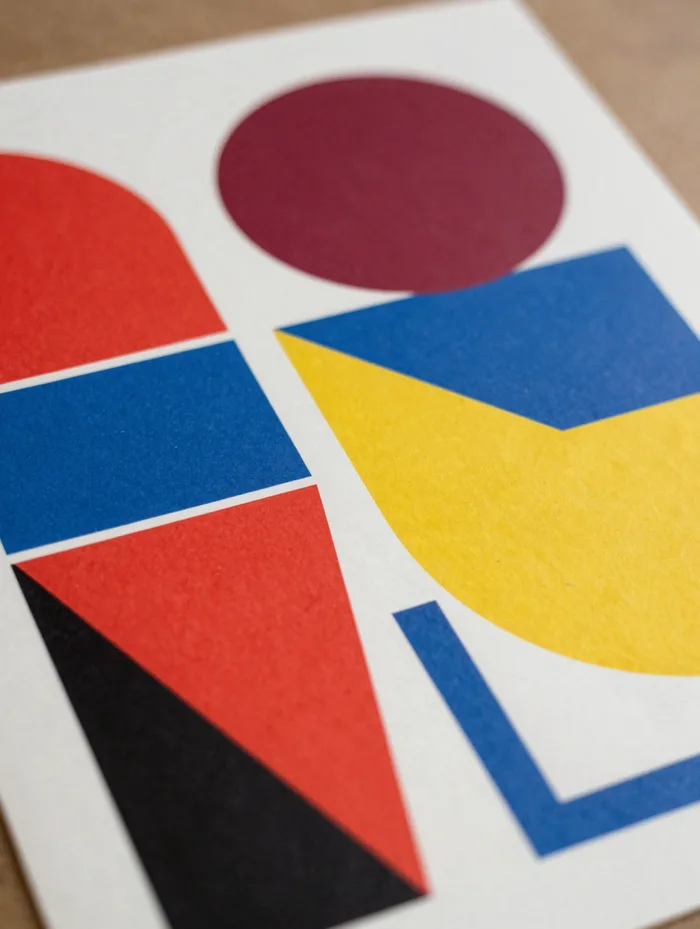 A bold Bauhaus-style poster in red, blue, and yellow geometric shapes