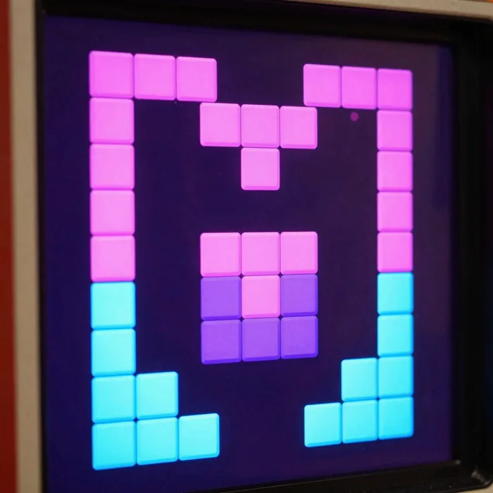 A retro falling-blocks arcade game screen in vivid neon