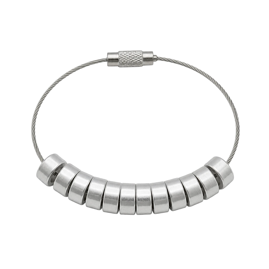 A small coil of plain aluminium bird rings on a wire loop