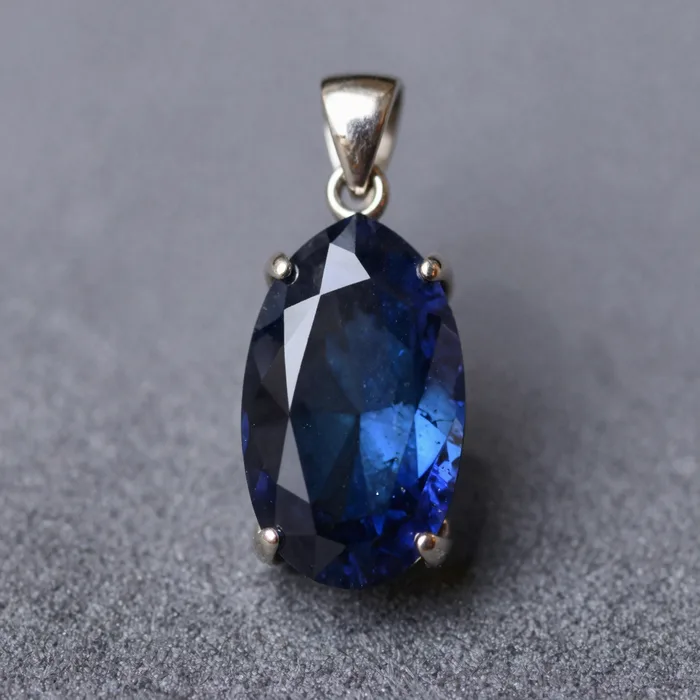 A tourmaline pendant on platinum against midnight blue, sparkling facets